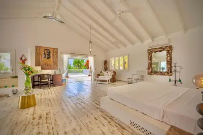 a large bedroom with a bed and a living room at Villa Azulsalado - Frente a la playa in Las Terrenas