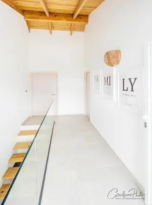 a staircase in a white room with wood ceilings at Syrma 302 Estrella Dominicus Apartment in La Laguna