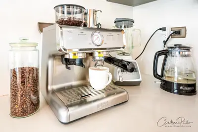 a coffee maker sitting on a counter with a cup of coffee at Syrma 302 Estrella Dominicus Apartment in La Laguna