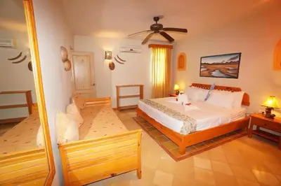 a bedroom with a bed and a ceiling fan at Villa Playa Bonita, Pool, Tropical Gardens in Las Terrenas