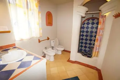 a bathroom with a toilet and a sink at Villa Playa Bonita, Pool, Tropical Gardens in Las Terrenas