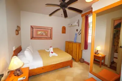 a bedroom with a bed and a ceiling fan at Villa Playa Bonita, Pool, Tropical Gardens in Las Terrenas