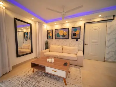 a living room with a white couch and a table at Garden Condos 5- Luxurious Apartment In Sosua Center in Sosúa