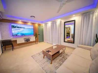 a living room with a couch and a table at Garden Condos 5- Luxurious Apartment In Sosua Center in Sosúa