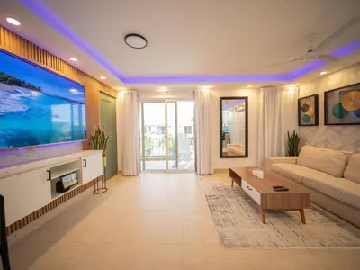 a living room with a couch and a large aquarium at Garden Condos 5- Luxurious Apartment In Sosua Center in Sosúa