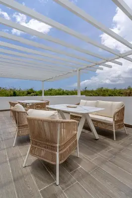 a patio with chairs and tables and a white canopy at Elegant Seaside Villa Steps to Beach & Golf Course in Boca del Soco