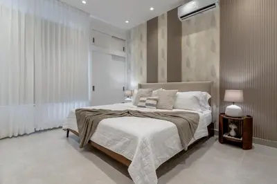 a bedroom with a large bed with white sheets and pillows at Elegant Seaside Villa Steps to Beach & Golf Course in Boca del Soco