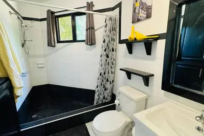 a bathroom with a shower and a toilet and a sink at Residencial Tropimar Sosua in Sosúa