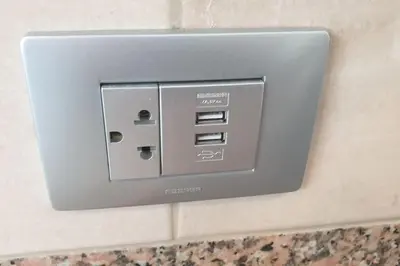 a lightswitch on a wall in a bathroom at CasaMia RD B&B in Río San Juan