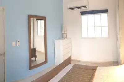 a mirror in a room with a bed and a window at CasaMia RD B&B in Río San Juan