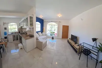 a large living room with a couch and a kitchen at CasaMia RD B&B in Río San Juan