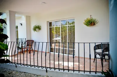 a balcony with chairs and a fence at White Sands Punta Cana - Pool-Jacuzzi in Punta Cana