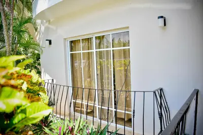 a white house with a balcony with a window at White Sands Punta Cana - Pool-Jacuzzi in Punta Cana