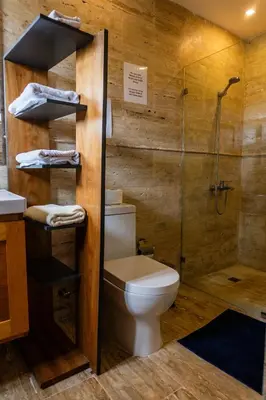 a bathroom with a toilet and a glass shower at Departamento en las Terrenas a pie de Playa in Las Terrenas