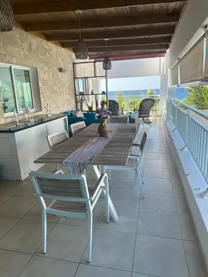 a wooden table and chairs on a patio at Paradise1 in Juan Dolio