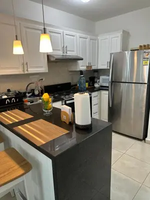a kitchen with a stainless steel refrigerator and black counter top at Paradise1 in Juan Dolio