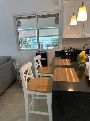 a kitchen with a table and chairs in a kitchen at Paradise1 in Juan Dolio