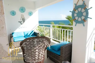 a balcony with chairs and a view of the ocean at Paradise1 in Juan Dolio