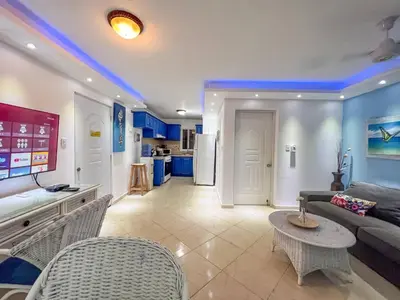 a living room with a couch and a table at Garden Condos 43, Modern Condo In Sosa Center in Sosúa