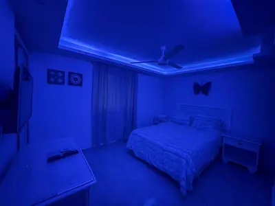 a blue bedroom with a bed and a blue ceiling at Garden Condos 43, Modern Condo In Sosa Center in Sosúa