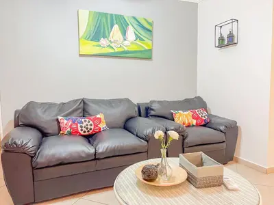 a living room with a couch and a table at Garden Condos Apt 44 - Comfy 1br Apt In Sosua in Sosúa