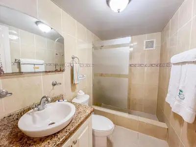 a bathroom with a sink and a toilet and a shower at Garden Condos Apt 44 - Comfy 1br Apt In Sosua in Sosúa