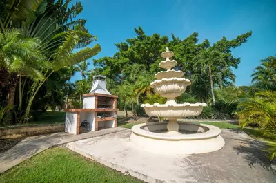 a fountain in the middle of a park at Garden Condos Apt 35 - Affordable 1br Apt In Sosua in Sosúa