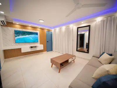 a living room with a couch and a flat screen tv at Garden Condos 39, Luxury Apartment In Sosua Town in Sosúa