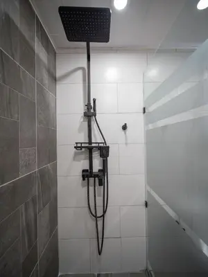 a shower with a shower head in a bathroom at Garden Condos 39, Luxury Apartment In Sosua Town in Sosúa