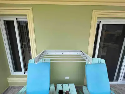 two blue chairs sitting in front of a house at Garden Condos 39, Luxury Apartment In Sosua Town in Sosúa