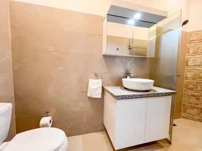 a bathroom with a toilet and a sink at Plaza Achim 7, Luxury Apt 250m From Sosua Beach in Sosúa