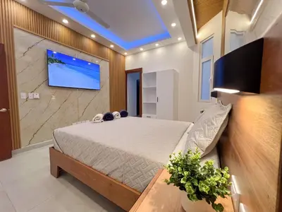 a bedroom with a bed and a tv on a wall at Plaza Achim 7, Luxury Apt 250m From Sosua Beach in Sosúa