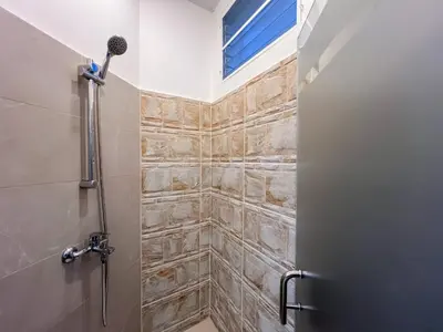 a bathroom with a shower stall with a microphone at Plaza Achim 7, Luxury Apt 250m From Sosua Beach in Sosúa