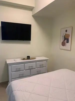 a bedroom with a bed and a tv on the wall at Mi lugar de descanso in Moca