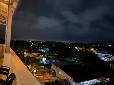a view of a city at night from a building at Mi lugar de descanso in Moca