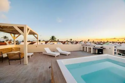 a pool on the roof of a building with a patio at Beach Homes Punta Cana in Punta Cana