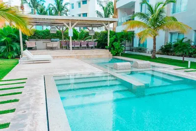 a swimming pool in front of a building at Beach Homes Punta Cana in Punta Cana