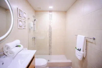 a bathroom with a shower and a toilet and a sink at Xeliter Las Olas Juan Dolio in Guayacanes