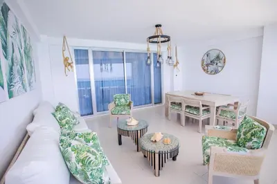 a living room with a couch and chairs and a table at Xeliter Las Olas Juan Dolio in Guayacanes