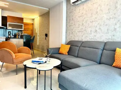 a living room with a couch and a table at Deluxe_Suite_1BDR_POOL_GYM_SAUNE in Santo Domingo