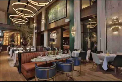 a dining room with tables and chairs in a restaurant at RoyalSuite 1BDR-Poll-Gym-Saune-g17 in Santo Domingo