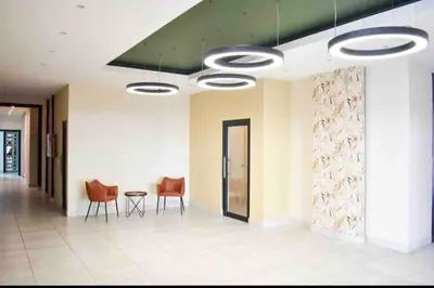 a hallway with chairs and a table in a building at RoyalSuite 1BDR-Poll-Gym-Saune-g17 in Santo Domingo
