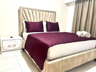 a bedroom with a large bed with purple sheets and pillows at Suite Bolívar 3bdr - Pool - Cine -Saune - SPA- A8 in Santo Domingo