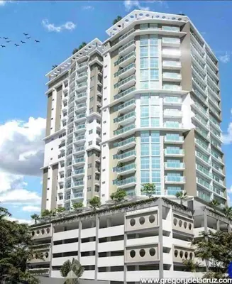 a tall white building with trees in front of it at Suite Bolívar 3bdr - Pool - Cine -Saune - SPA- A8 in Santo Domingo