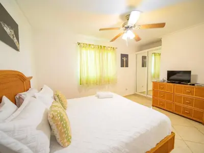 a bedroom with a bed and a ceiling fan at Garden Condos 40, 1br Apt In Sosua Strip Guest Ok in Sosúa