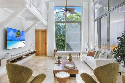 a living room with a couch and a table at Private Two-Storey Casa de Campo villa with pool, jacuzzi and golf cart in La Romana