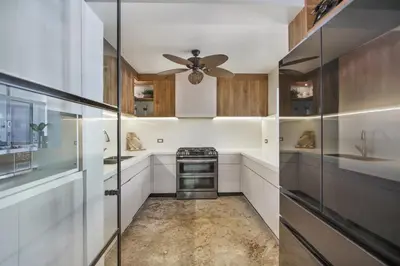 a kitchen with a ceiling fan and a stove at Private Two-Storey Casa de Campo villa with pool, jacuzzi and golf cart in La Romana