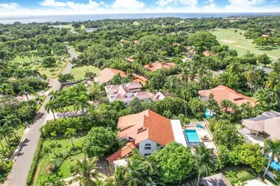 an aerial view of a home with palm trees at Private Two-Storey Casa de Campo villa with pool, jacuzzi and golf cart in La Romana