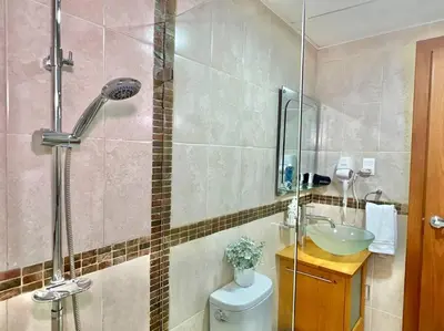 a bathroom with a shower and a toilet and a sink at Serenity by the Sea Oceanfront Apartment in San Pedro de Macorís