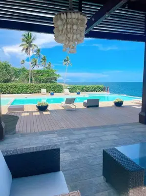 a view of a swimming pool with a chandelier at Serenity by the Sea Oceanfront Apartment in San Pedro de Macorís